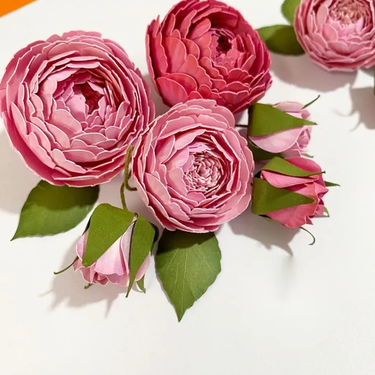 Ranúnculos de papel e botoes em tons de rosa